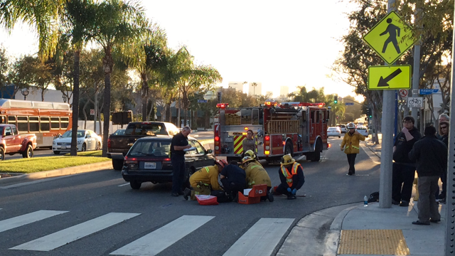 Firefighters treat a woman hit by a car on Santa Monica Boulevard at Ramage