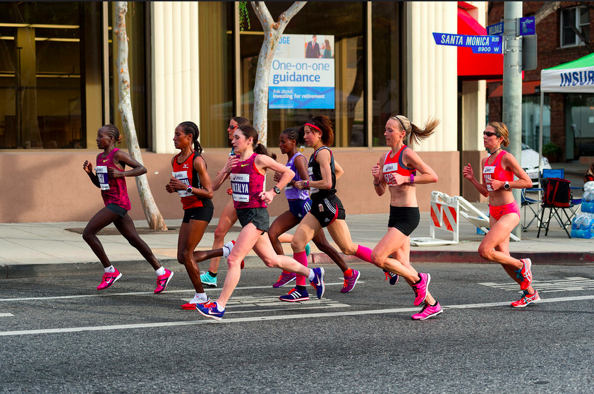 Women running down WeHo's Santa Monica Boulevard (Photo: Jon Viscott)