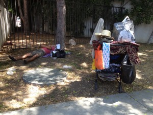 A homeless person with a cart full of belongings sleeping on WeHo's Eastside (Photo courtesy of Roxanne McBryde).