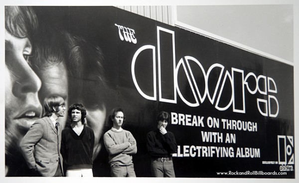 The Doors pose in front of the Sunset Strip billboard promoting their debut album in 1967. (Photo courtesy of Clear Channel Outdoor Archives)/