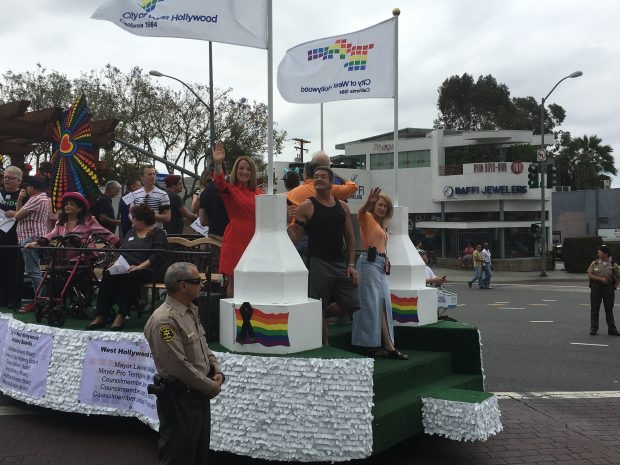 From left, City Councilmembers Lindsey Horvath (in red) and John Duran (in black tank top) and Mayor Lauren Meister (in orange blouse) on WeHo Commission float in LA Pride parade.