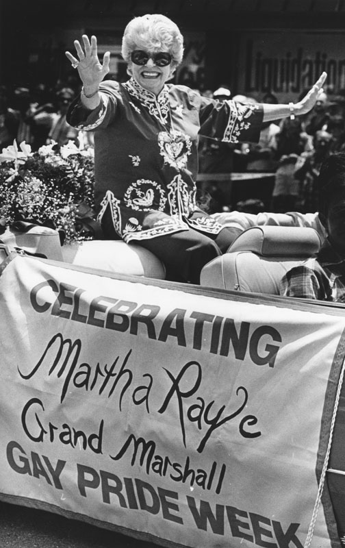 Photo of Grand Marshal Martha Raye riding in the 1982 Gay Parade and Festival in West Hollywood. (Photo by Anne Knudsen, Los Angeles Herald Examiner Collection, courtesy of the Los Angeles Public Library Collection)