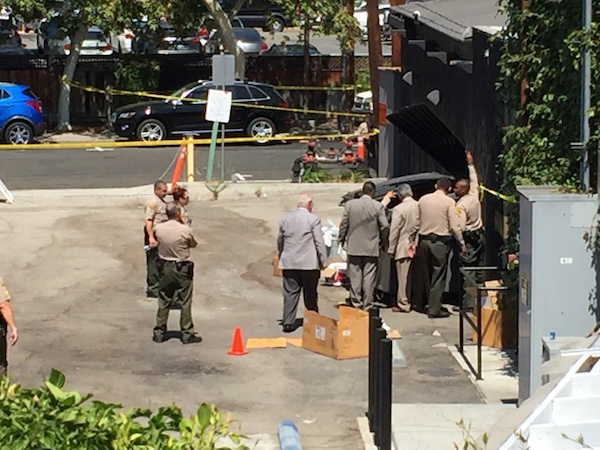 Sheriff's investigators around the dumpster behind Dominick's where a woman's body was found. (Photo courtesy of Aaron Micu).