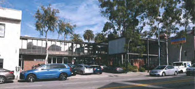8221 Santa Monica Blvd. is a two-story office building in the Mid-Century Modern style built in 1956. It displays the influences of celebrated Modern architect Mies van der Rohe in the rigid geometry. Characteristics of Mid- Century Modern design in this building are the flat roof, brick veneer, large single pane windows and the large geometric form constructed of steel beams that makes up the entry pavilion. Edwin W. Kahn was the engineer associated with this building.
